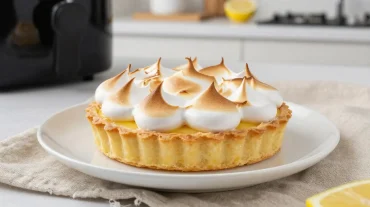Délicieuse tarte au citron meringuée préparée au airfryer avec une croûte dorée.